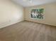 Large bedroom with neutral carpeting, ceiling fan and large window at 1711 Shadow View Cir # 1711, Maitland, FL 32751