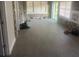 Spacious sunroom with stone wall and new flooring at 401 Martin Luther King Jr Ave, Wildwood, FL 34785