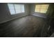 Bright bedroom with new wood flooring and large windows at 401 Martin Luther King Jr Ave, Wildwood, FL 34785