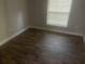 Simple bedroom with new flooring and window blinds at 401 Martin Luther King Jr Ave, Wildwood, FL 34785