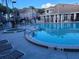 Community pool and spa with surrounding lounge chairs at 3100 Parkway Blvd # 748, Kissimmee, FL 34747