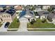 Aerial view of a house with solar panels and a neighborhood at 356 Nova Dr, Davenport, FL 33837