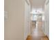 Light hallway with hardwood floors leading to a bedroom at 10068 Chardonnay Dr, Orlando, FL 32832