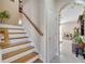 Elegant staircase with wood and white risers, leading to upper level at 10068 Chardonnay Dr, Orlando, FL 32832