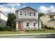 Two-story home with gray and beige siding, orange door and front porch at 12614 Clear Sapphire Dr # 137, Winter Garden, FL 34787