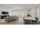 Open living and dining area with grey sofa and large TV at 12614 Clear Sapphire Dr # 137, Winter Garden, FL 34787