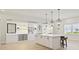 White kitchen with large island and various lighting options at 12614 Clear Sapphire Dr # 137, Winter Garden, FL 34787