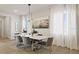 Modern dining room features a marble table, stylish chairs, and large windows at 12614 Clear Sapphire Dr # 137, Winter Garden, FL 34787