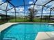 Inviting screened pool with a spacious backyard view at 2708 Fiesta Key Dr, Kissimmee, FL 34747