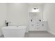Bathroom with double vanity, large soaking tub, and modern fixtures at 494 Marion Oaks Trl, Ocala, FL 34473