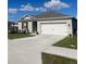 One-story house with a two-car garage, landscaped lawn, and neutral exterior at 564 Boardwalk Ave, Haines City, FL 33844