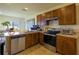 Updated kitchen with stainless steel appliances and wood cabinets at 564 Boardwalk Ave, Haines City, FL 33844
