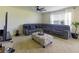 Relaxing living room with sectional sofa, large TV, and ceiling fan at 564 Boardwalk Ave, Haines City, FL 33844