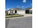 Single-story house with neutral color scheme, two-car garage, and nicely landscaped front yard at 564 Boardwalk Ave, Haines City, FL 33844