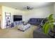 Spacious living room with sectional sofa, coffee table, and large TV at 564 Boardwalk Ave, Haines City, FL 33844