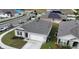 An aerial view of a single-story house in a community with solar panels at 564 Boardwalk Ave, Haines City, FL 33844