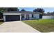 Modern home with a dark gray garage door and white exterior at 6748 Cherry Rd, Ocala, FL 34472