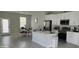 Modern kitchen with island, stainless steel appliances, and dining area at 6748 Cherry Rd, Ocala, FL 34472