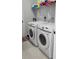 Bright laundry room with Samsung washer and dryer, and ample shelving at 6748 Cherry Rd, Ocala, FL 34472