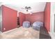 Media room with red walls, projector, and comfortable beanbag chairs at 1518 Alligator St, Saint Cloud, FL 34771