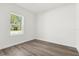 Simple bedroom with wood-look floors and a window at 494 Marion Oaks Trl, Ocala, FL 34473