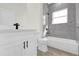 Modern bathroom with a bathtub and gray marble-look walls at 494 Marion Oaks Trl, Ocala, FL 34473