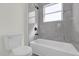 Clean bathroom with a shower/tub combo and gray tile at 494 Marion Oaks Trl, Ocala, FL 34473