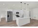 Modern kitchen with white cabinets, stainless steel appliances, and a large island at 494 Marion Oaks Trl, Ocala, FL 34473