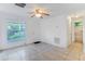 Living room with tile floors, door to exterior, and view to backyard at 1422 N Highland St, Mount Dora, FL 32757