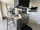 Luxury outdoor kitchen with stainless steel appliances and a large island at 331 Muirfield Loop, Reunion, FL 34747
