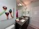 Modern bathroom with double vanity and granite countertop at 331 Muirfield Loop, Reunion, FL 34747