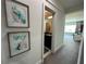 Bright hallway with artwork leading to a bathroom and bedroom at 331 Muirfield Loop, Reunion, FL 34747