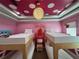 Fun bunk beds in a playful bedroom with a pink polka dot ceiling at 331 Muirfield Loop, Reunion, FL 34747