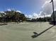 Two lighted tennis courts with a surrounding fence at 331 Muirfield Loop, Reunion, FL 34747