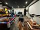 Spacious game room with multiple games and a large screen at 331 Muirfield Loop, Reunion, FL 34747