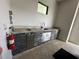 Outdoor kitchen features granite countertops, stainless steel appliances, and a built-in grill at 331 Muirfield Loop, Reunion, FL 34747