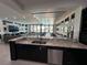 Open kitchen with granite island and view to the living area at 331 Muirfield Loop, Reunion, FL 34747