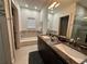 Elegant bathroom with double vanity, soaking tub, and tile shower at 331 Muirfield Loop, Reunion, FL 34747