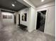 Modern hallway with gray tiled floors and two doors leading to bathrooms at 331 Muirfield Loop, Reunion, FL 34747