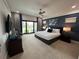 Bright bedroom with king bed, access to balcony, and golf course view at 331 Muirfield Loop, Reunion, FL 34747