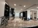 Modern kitchen with dark cabinetry and granite countertops at 331 Muirfield Loop, Reunion, FL 34747