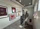 Elegant staircase with modern metal railing and art gallery wall at 331 Muirfield Loop, Reunion, FL 34747