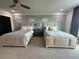 Spacious bedroom with two queen beds and neutral decor at 331 Muirfield Loop, Reunion, FL 34747