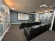State-of-the-art home theater with plush reclining seats and large projection screen at 331 Muirfield Loop, Reunion, FL 34747