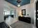Elegant entryway with modern console table and statement mirror at 331 Muirfield Loop, Reunion, FL 34747