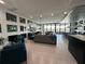 Open living space featuring comfortable seating and large windows at 331 Muirfield Loop, Reunion, FL 34747