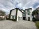 Contemporary three-story house with stone accents at 331 Muirfield Loop, Reunion, FL 34747