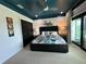 Bedroom with a king-size bed and dark teal ceiling at 331 Muirfield Loop, Reunion, FL 34747
