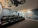 Elegant home theater with dark-colored reclining seats and wall art at 331 Muirfield Loop, Reunion, FL 34747