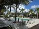 Expansive pool area with numerous lounge chairs and patio tables at 331 Muirfield Loop, Reunion, FL 34747